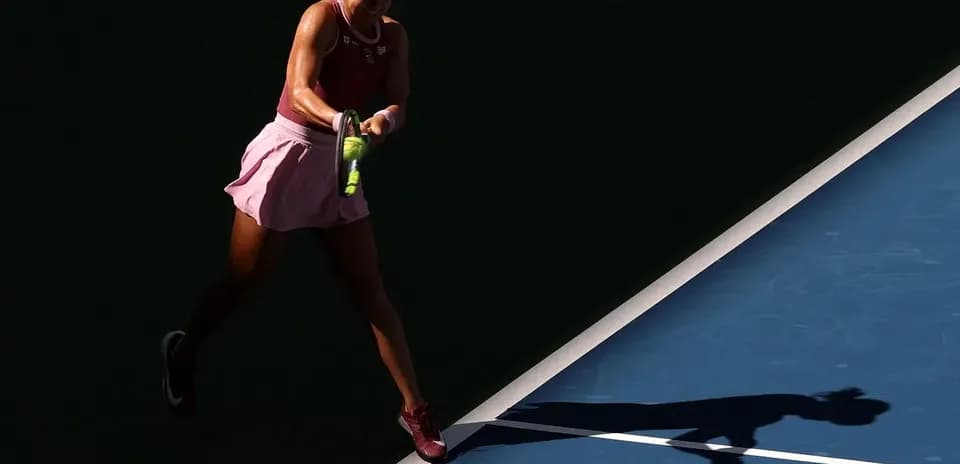Tennis player hitting a forehand on court