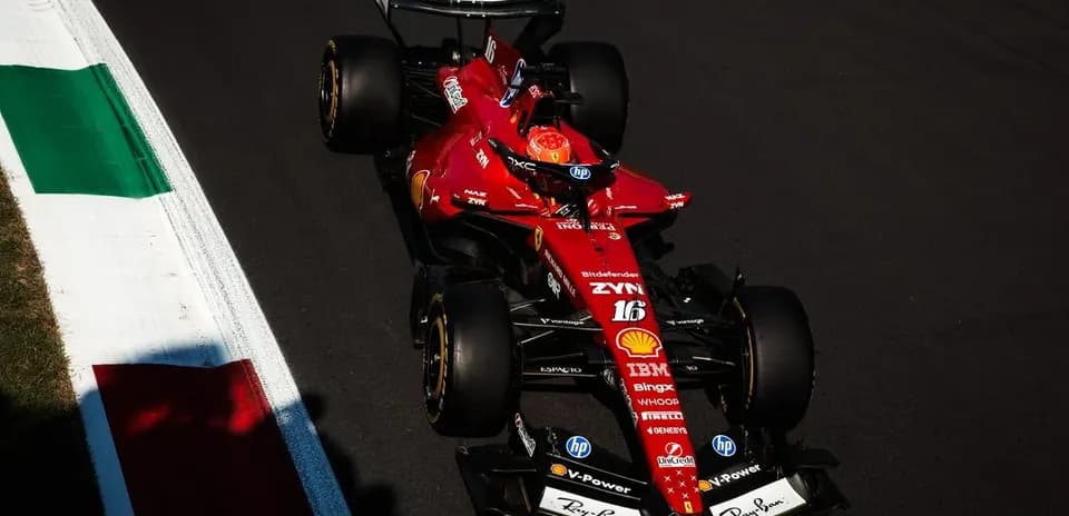 Ferrari F1 car navigating a track corner