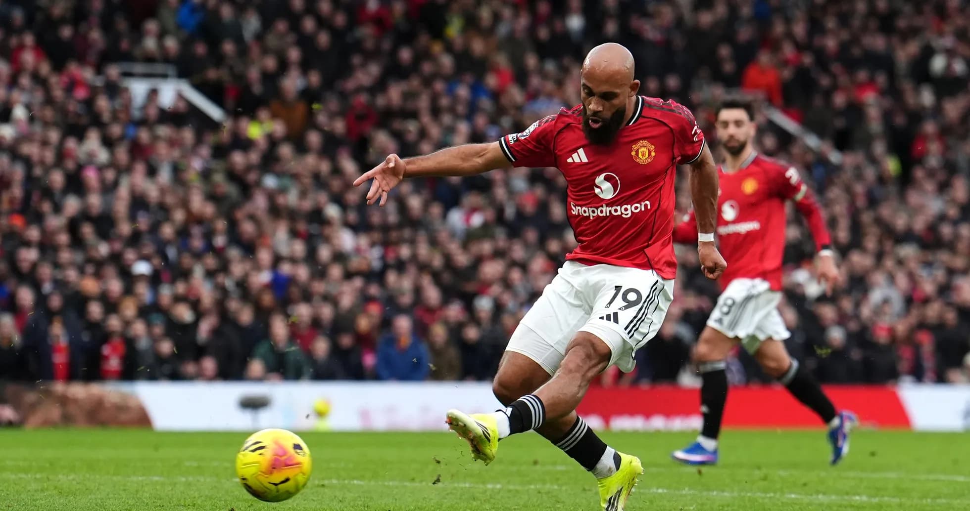 Manchester United player taking a shot on goal