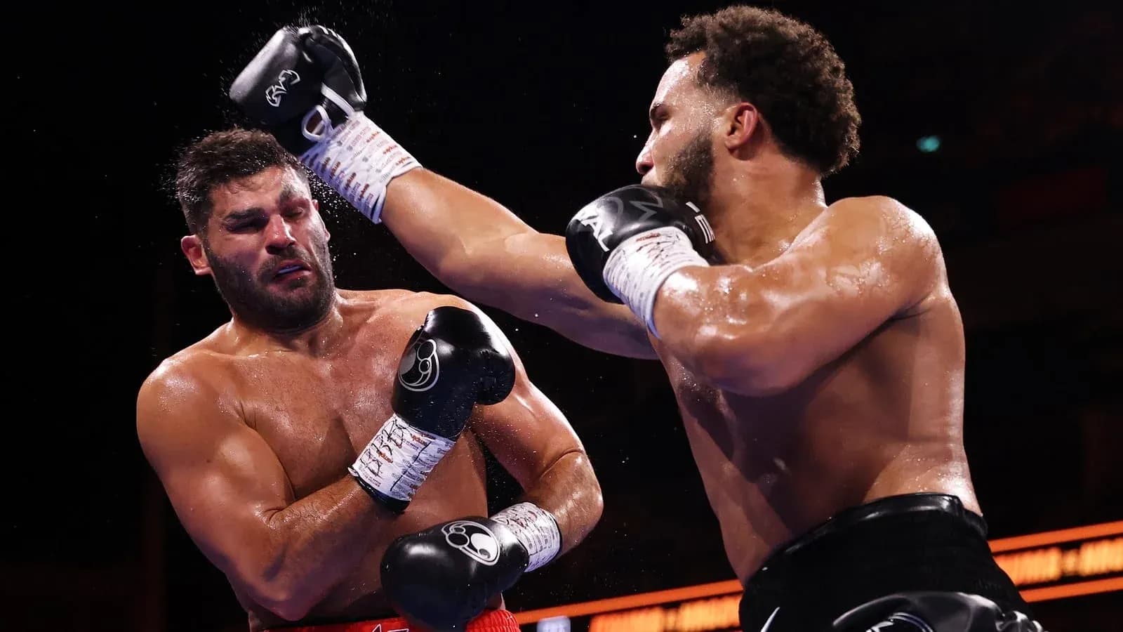 Boxers exchanging punches during a boxing match