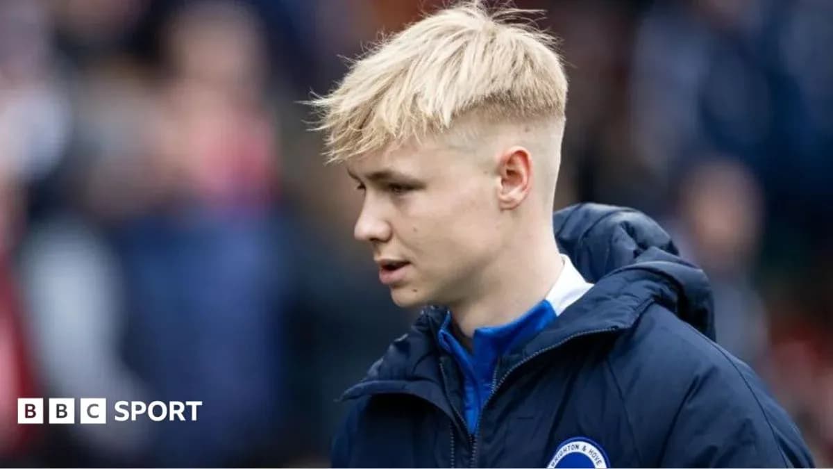 Player walking on the pitch in team jacket