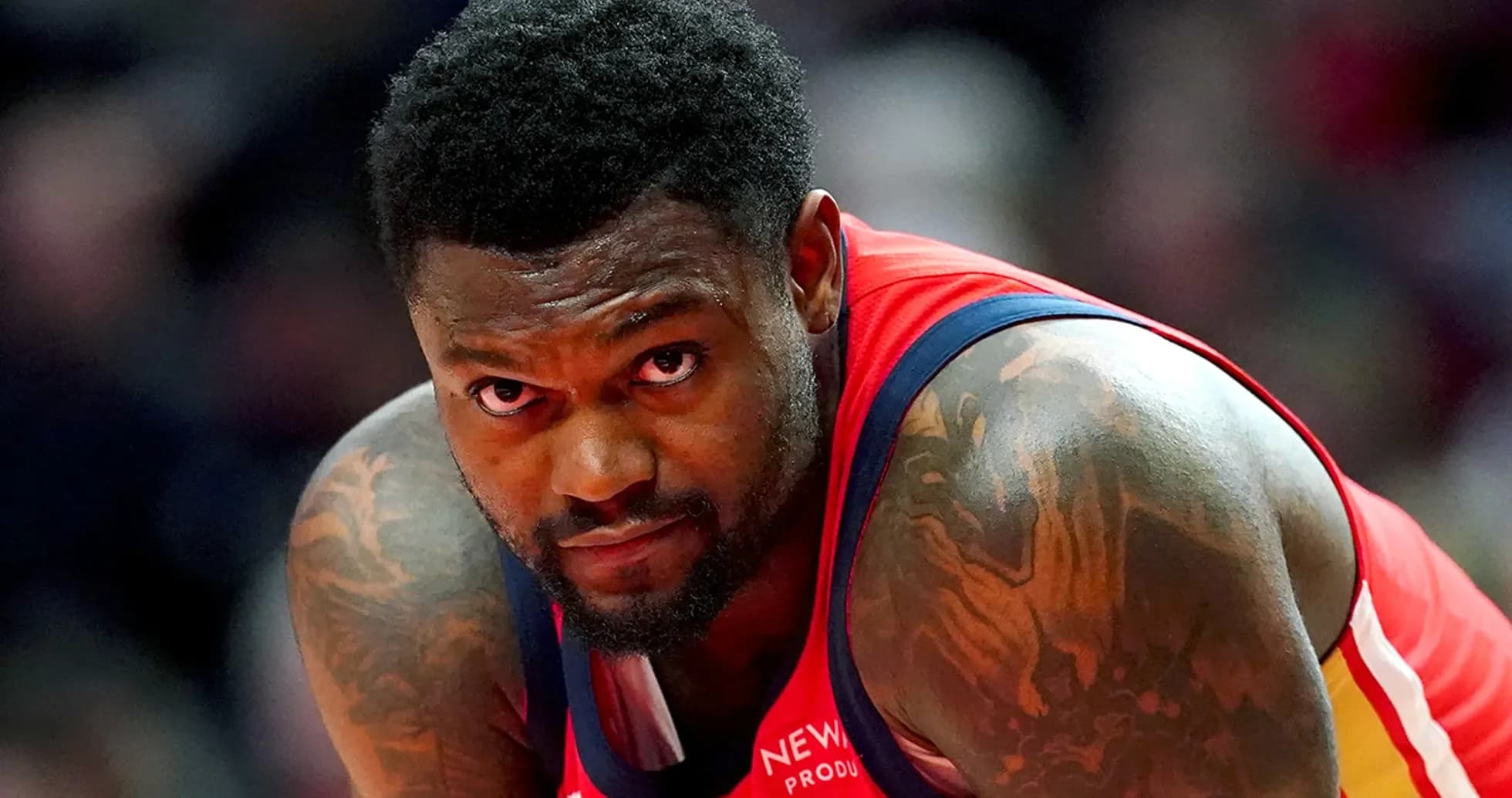 Basketball player in red jersey looking focused