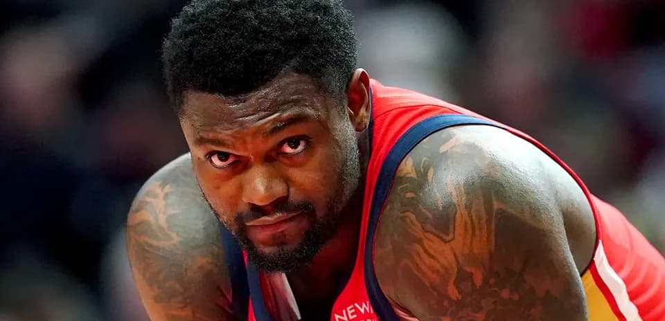 Basketball player in red jersey looking focused
