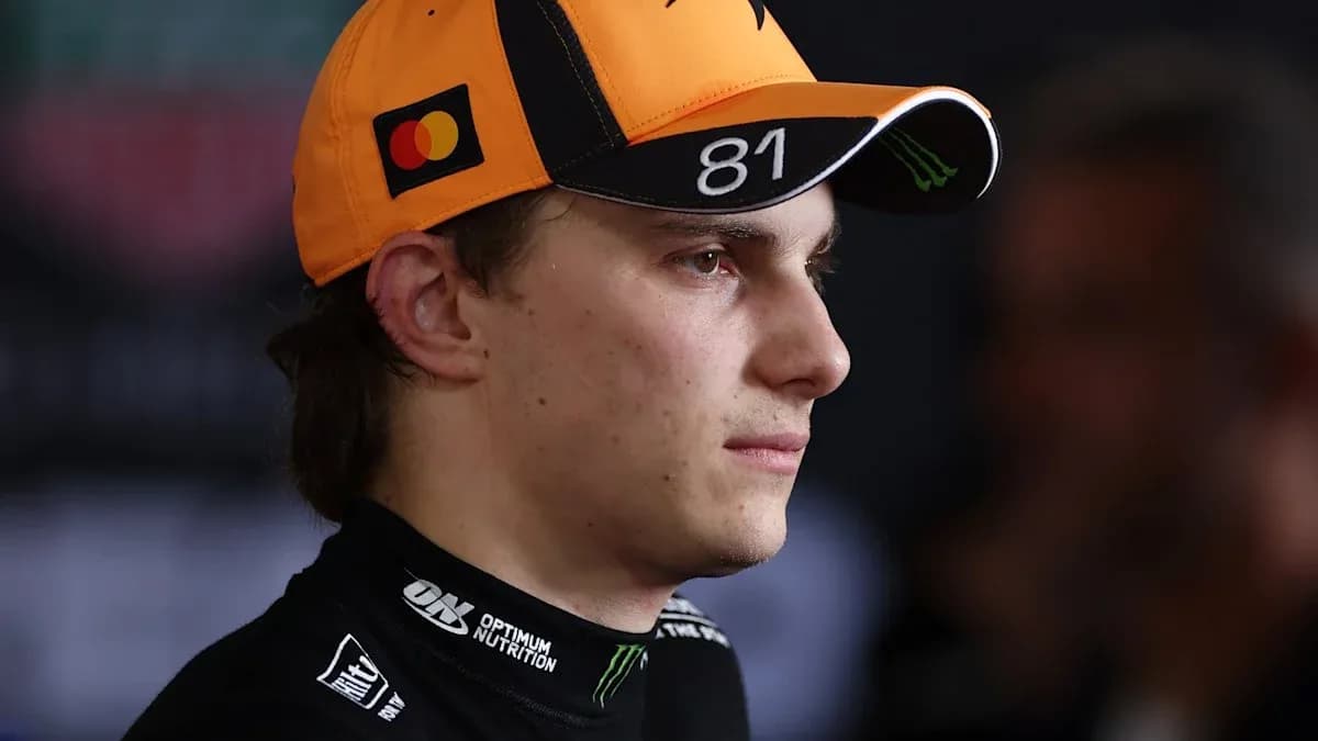 Driver wearing an orange cap during press event