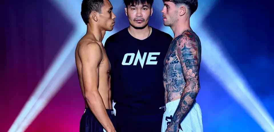 Two fighters facing off with official in between