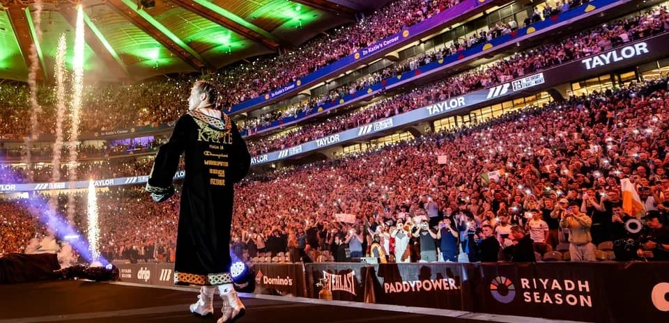 Boxer entering arena with fireworks and cheering crowd