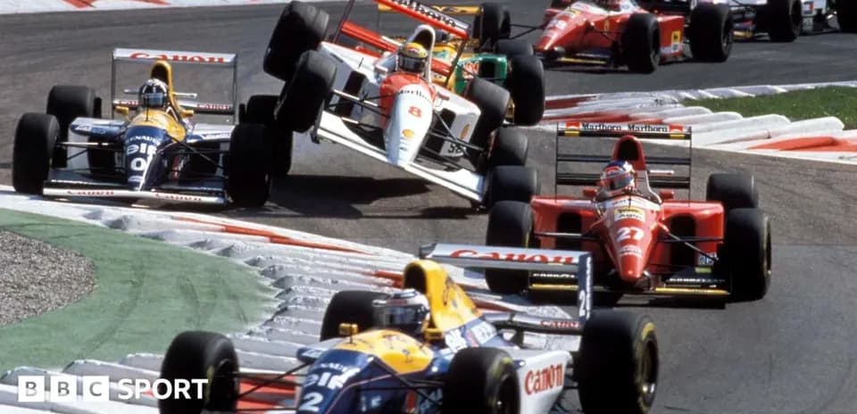 Formula 1 cars racing on a track corner