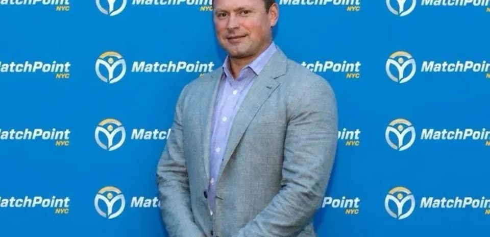 Person posing in front of MatchPoint NYC backdrop