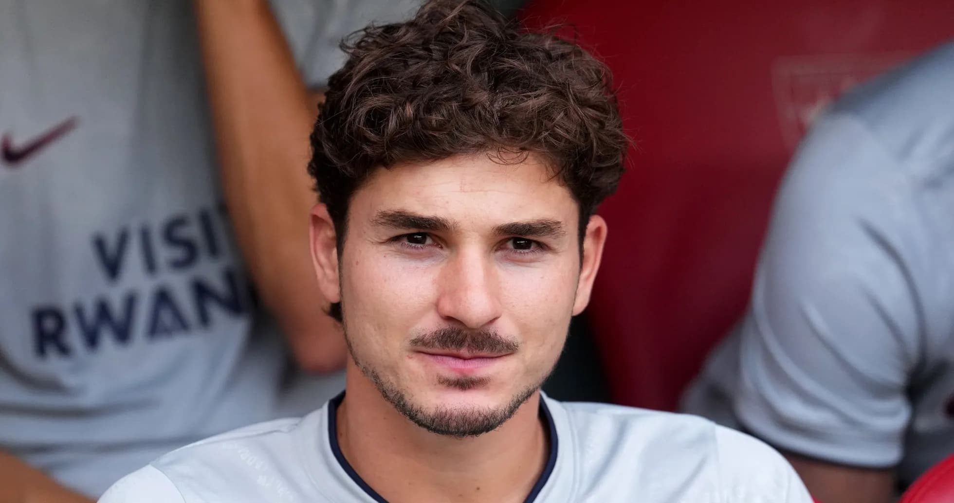Player seated on bench during match preparation