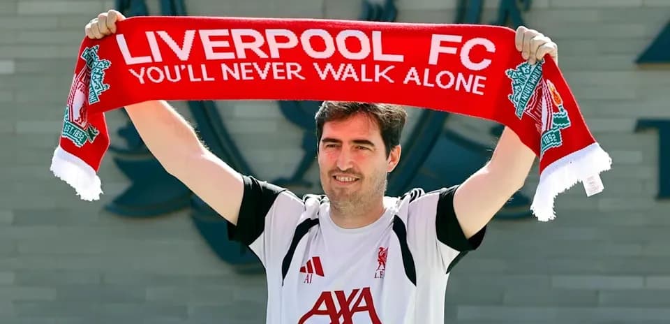 Person holding Liverpool FC scarf at club venue