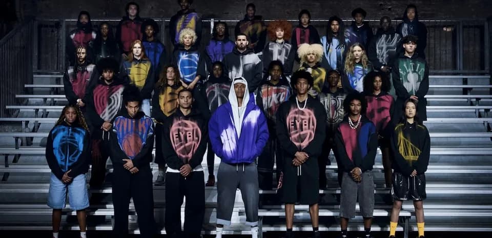 Group of models wearing colorful hoodies on bleachers