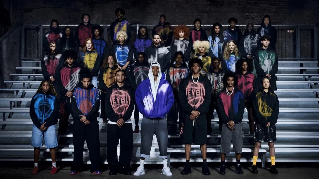 Group of models wearing colorful hoodies on bleachers
