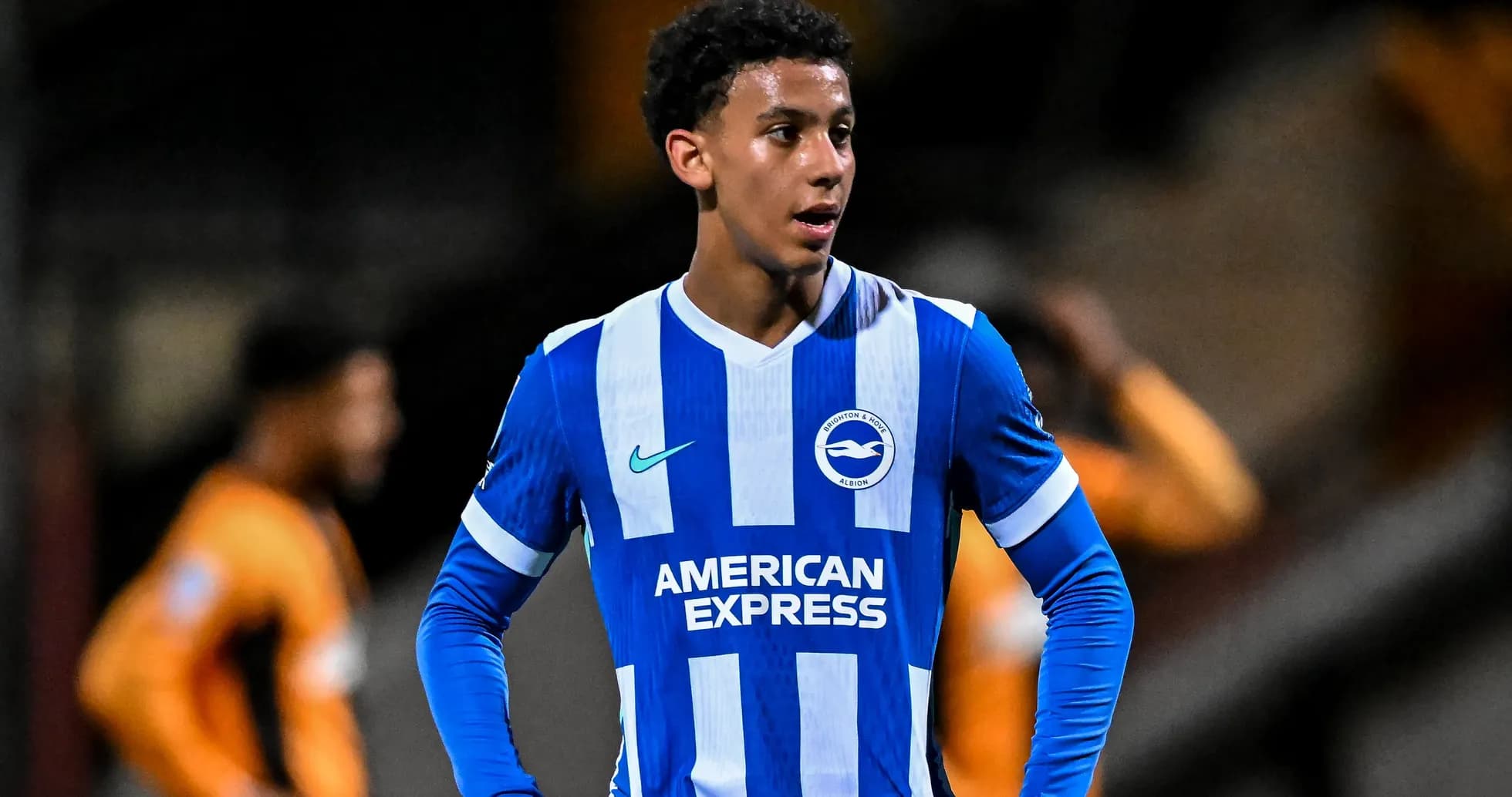Player wearing Brighton & Hove Albion jersey on field