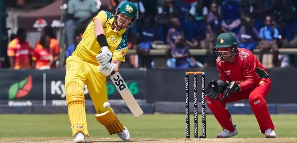 Batsman hitting the ball with wicketkeeper ready