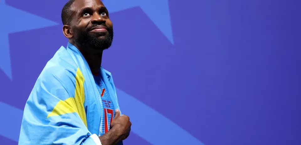 Athlete wearing a flag, looking up during event