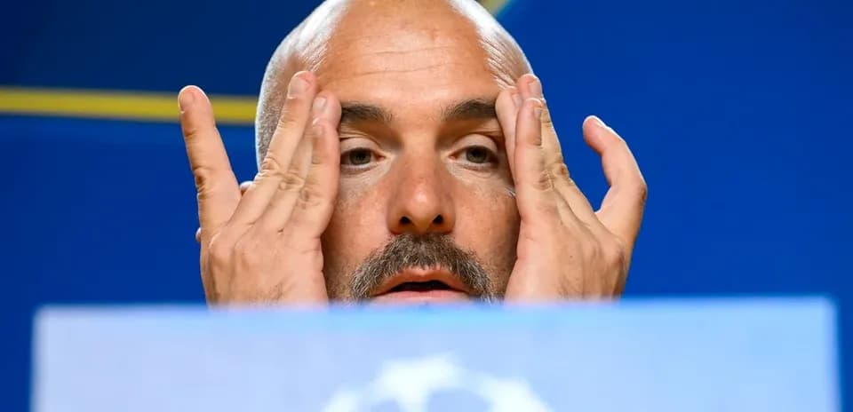 Manager speaking during press conference with hands on face
