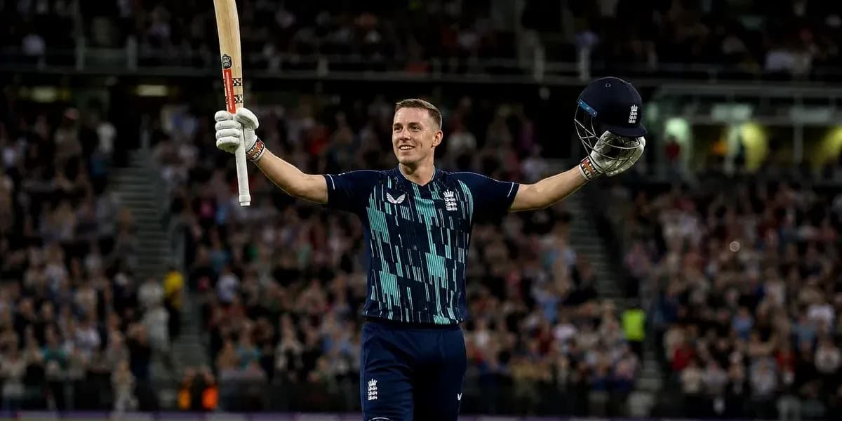 Batsman celebrating with bat and helmet raised