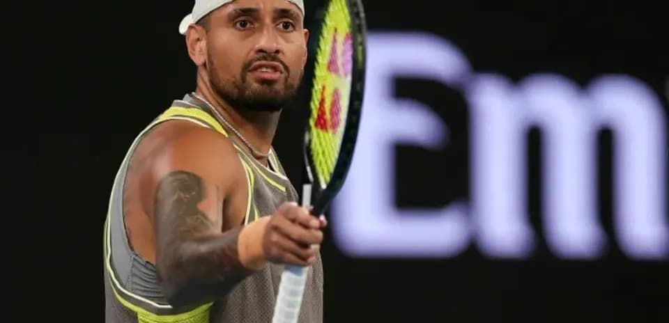 Tennis player holding racket during match action