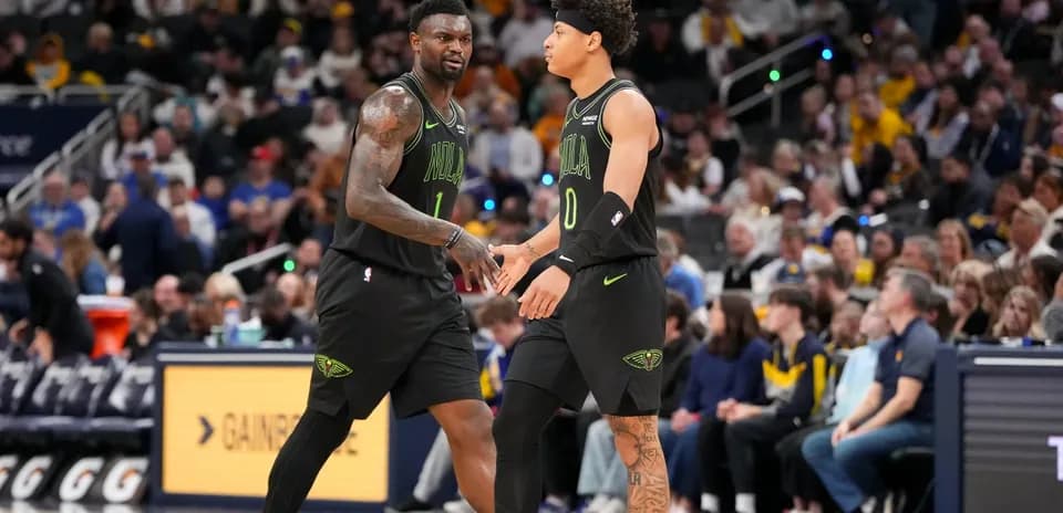 Two basketball players exchanging a handshake during game