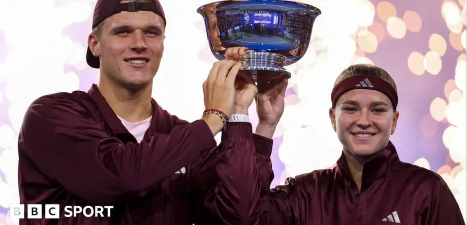 Players celebrating with trophy after winning tournament