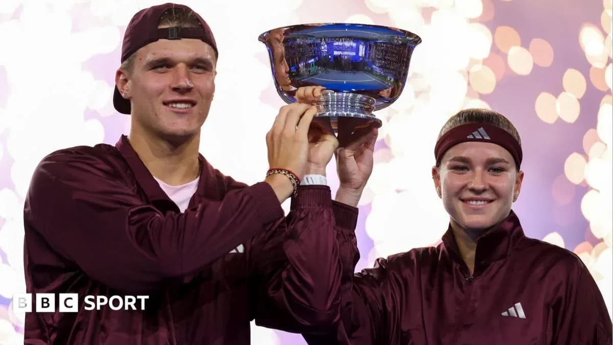 Players celebrating with trophy after winning tournament