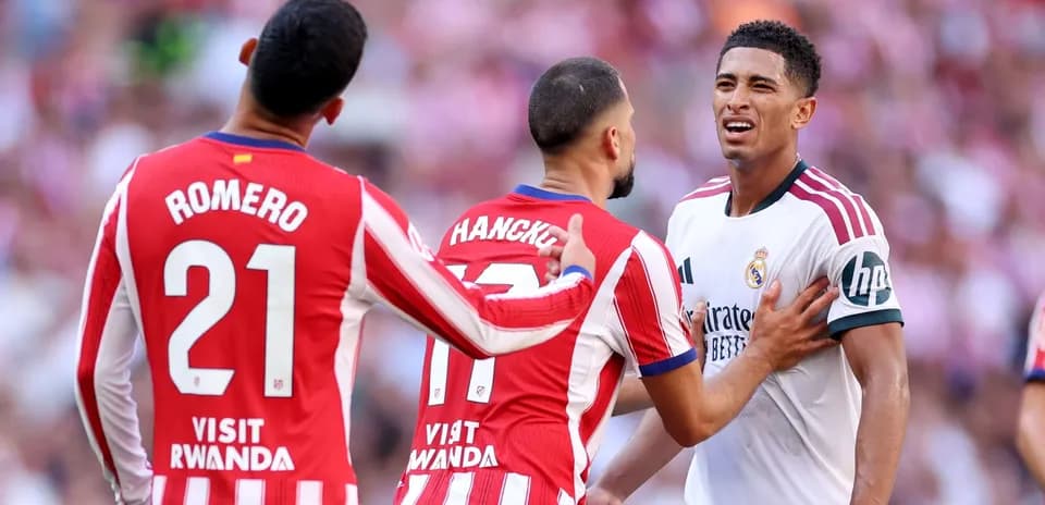 Atletico Madrid players confronting Real Madrid player