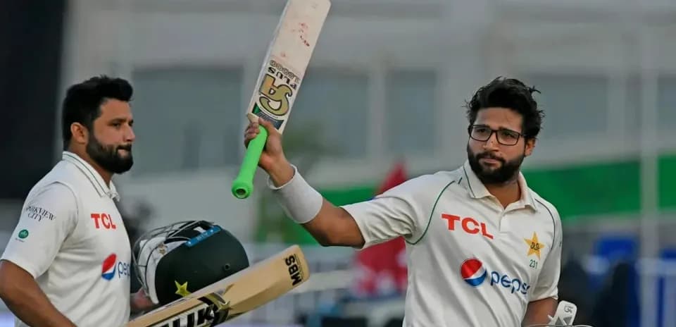 Batsman celebrating a milestone with teammate during match