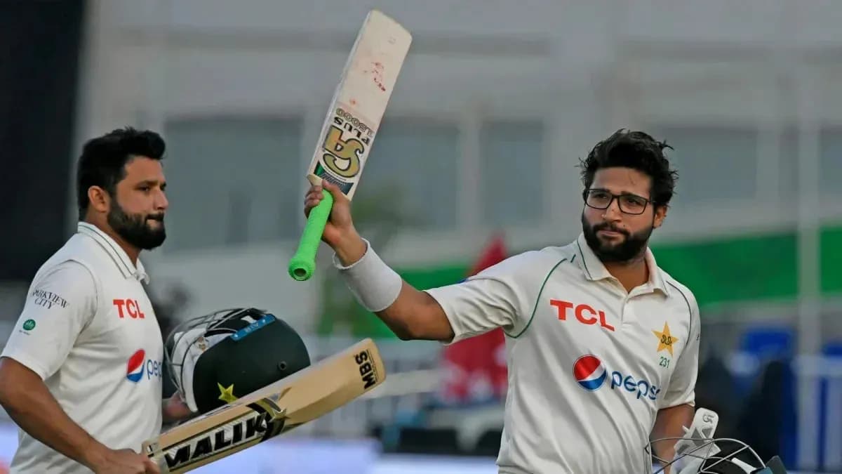 Batsman celebrating a milestone with teammate during match