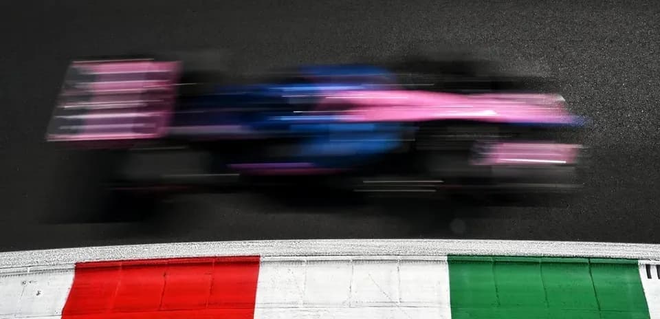 Formula 1 car speeding past colorful track markings