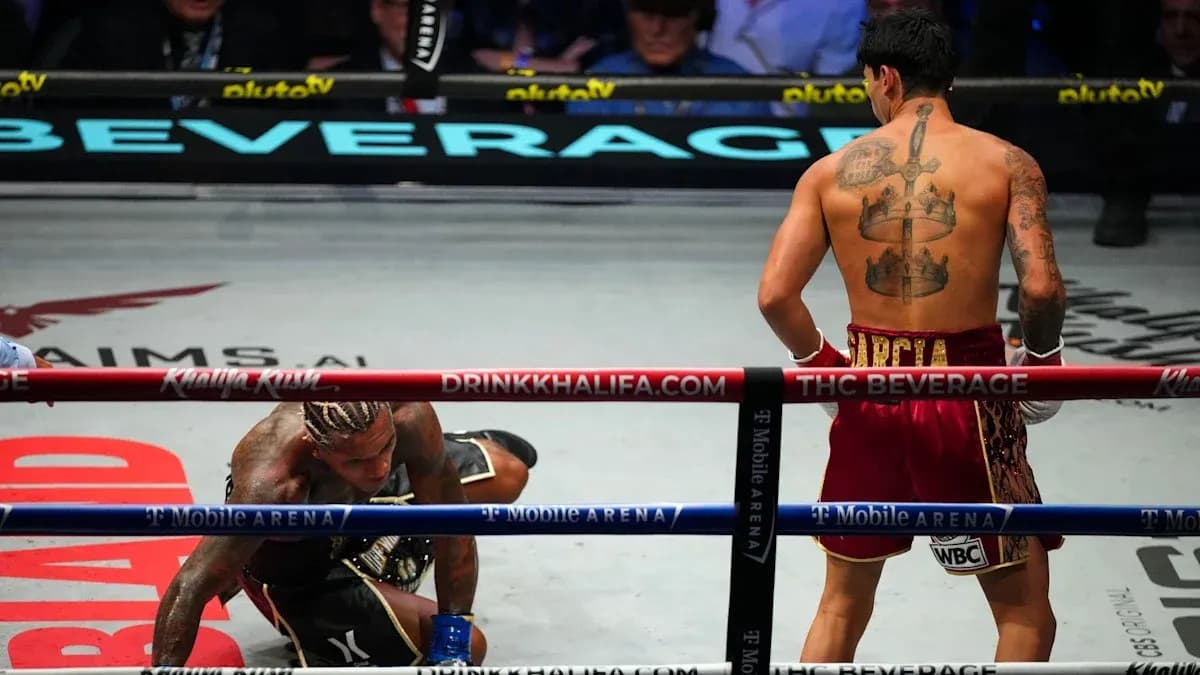 Boxer on the canvas, opponent standing in ring