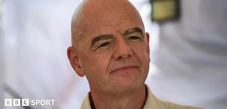 Person with shaved head speaking at an event
