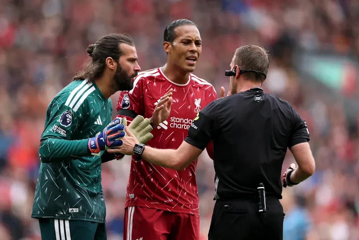 Liverpool players discussing with the referee during match