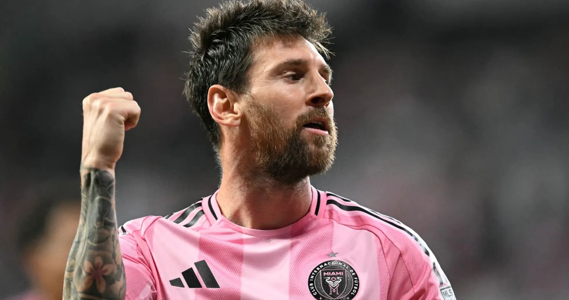Player celebrating in pink jersey after a match