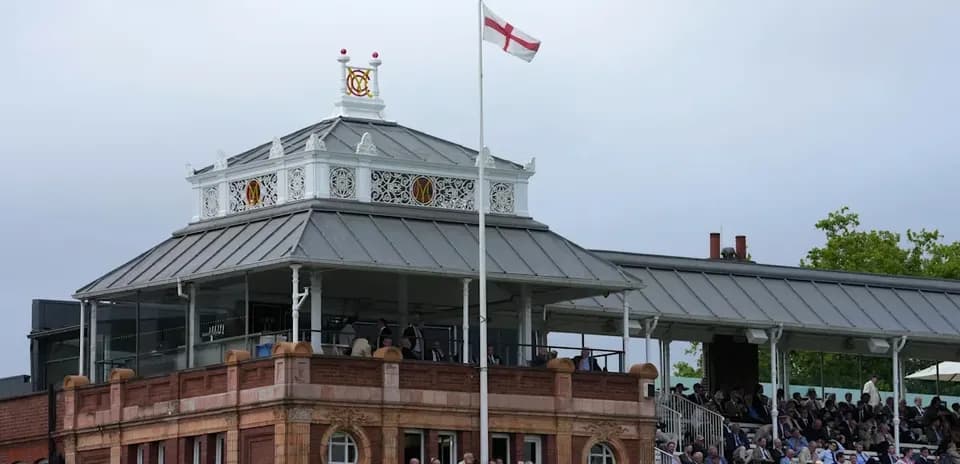 Spectators watching from the pavilion at Lord's cricket ground