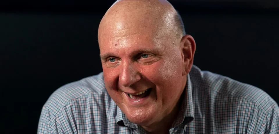 Man smiling while sitting at a table