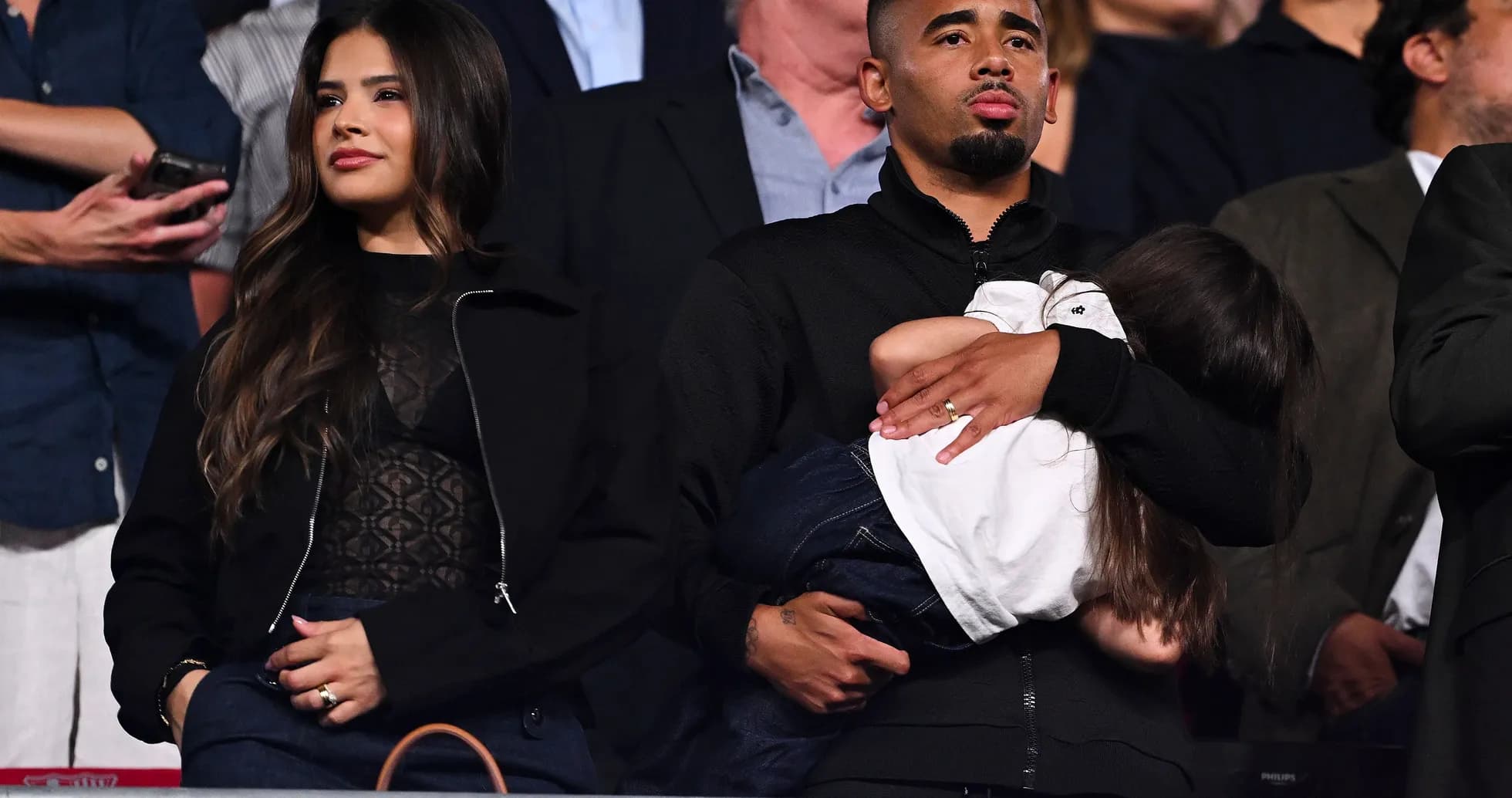 Couple with child in audience at event