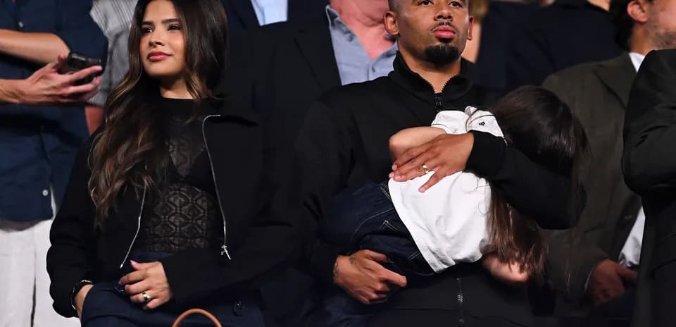 Couple with child in audience at event