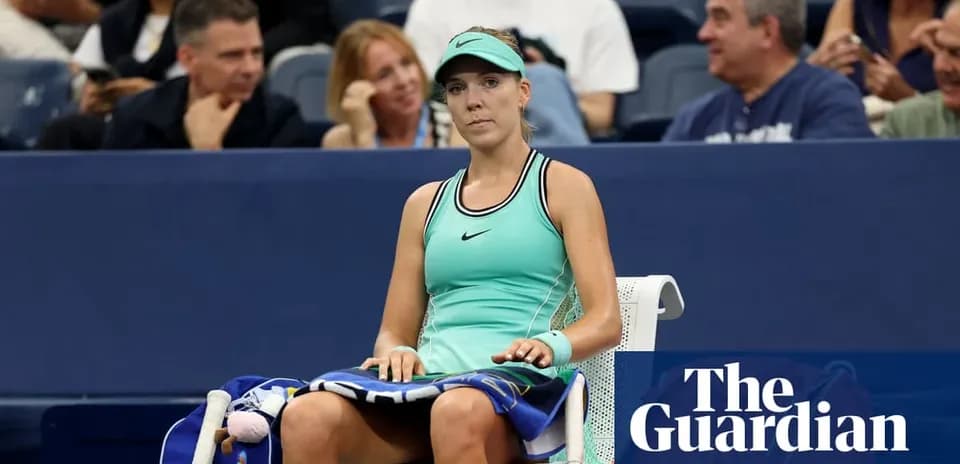 Tennis player sitting on bench during match