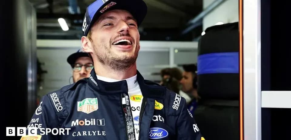 Driver smiling in team garage before race