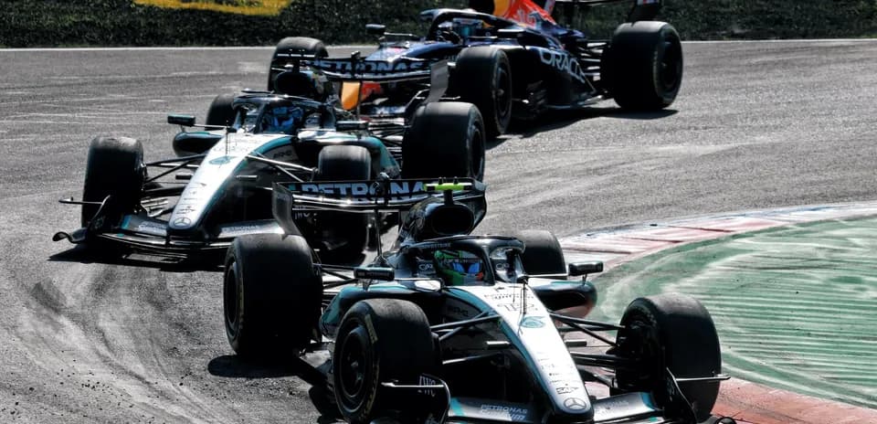 Three Formula 1 cars racing on track