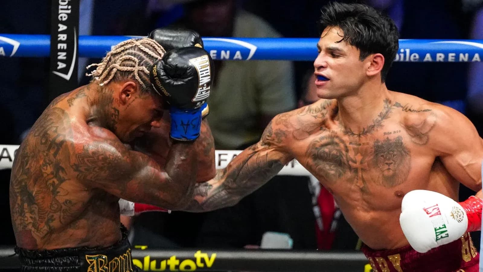 Two boxers exchanging punches in the ring
