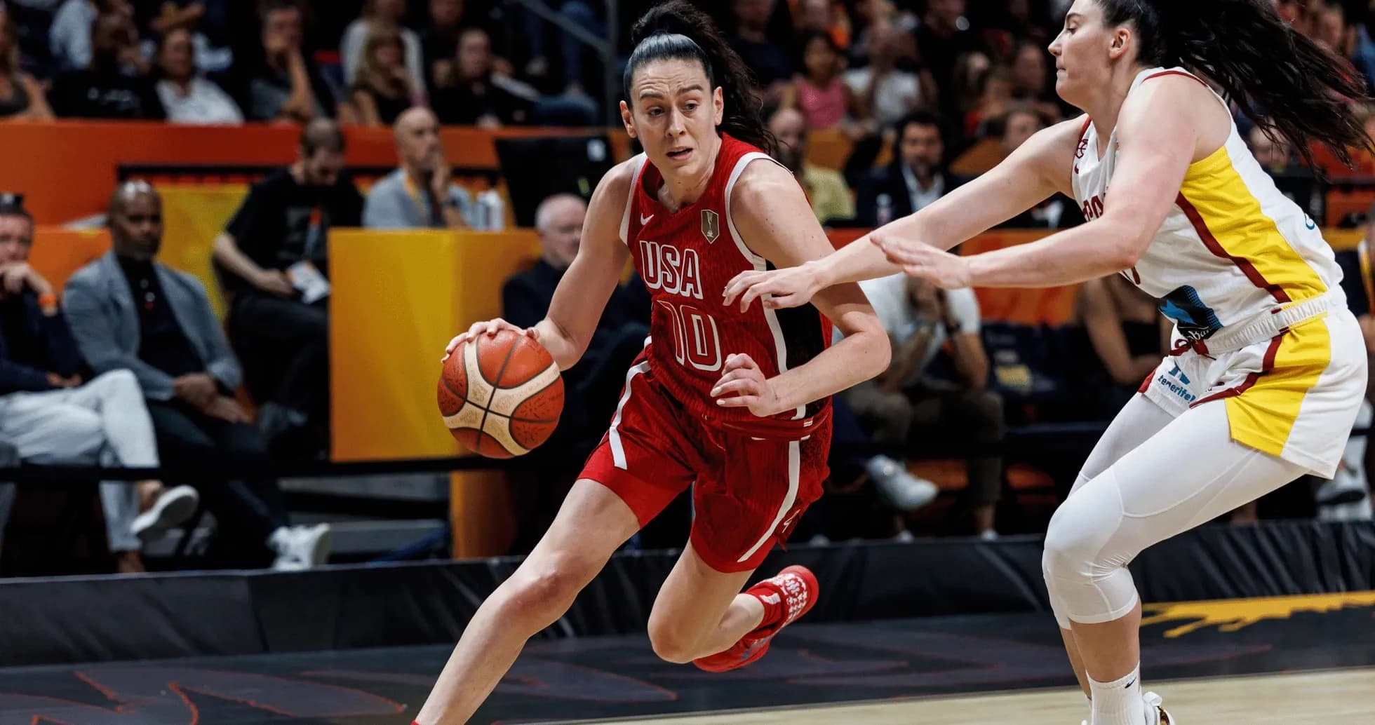 USA player dribbling past defender in basketball game