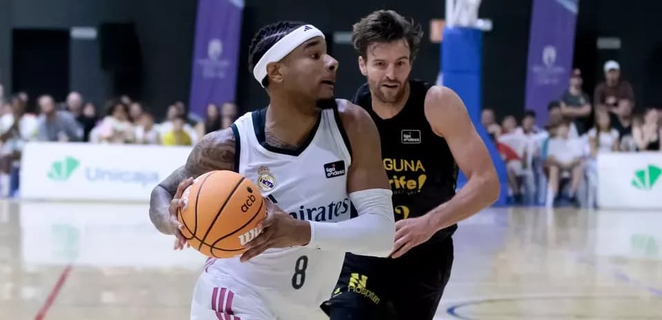 Player dribbling basketball while being closely guarded
