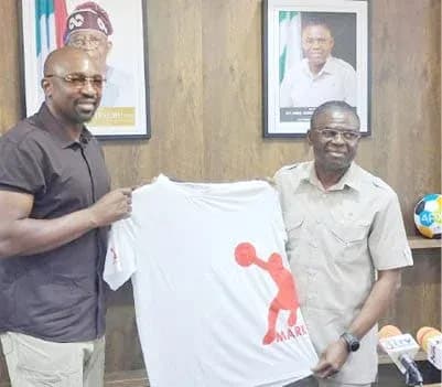 Two men presenting a T-shirt in an office