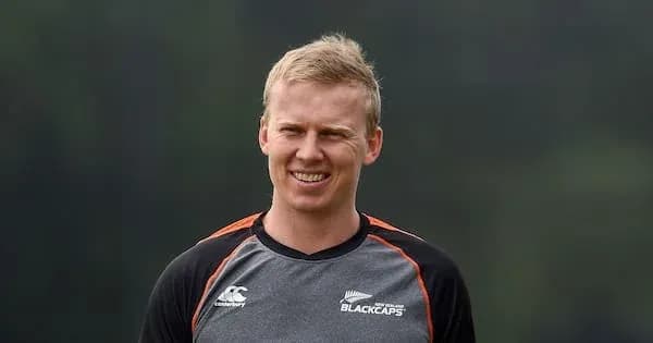 Cricketer in Blackcaps training uniform smiling outdoors