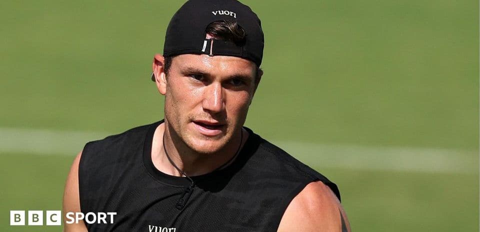 Athlete training on the field in black tank top