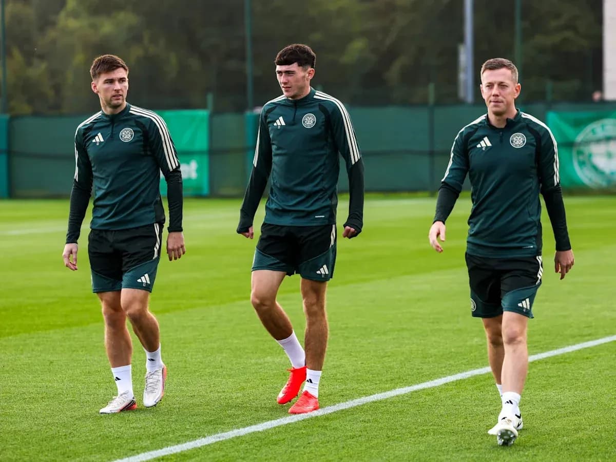 Three players walking on training pitch