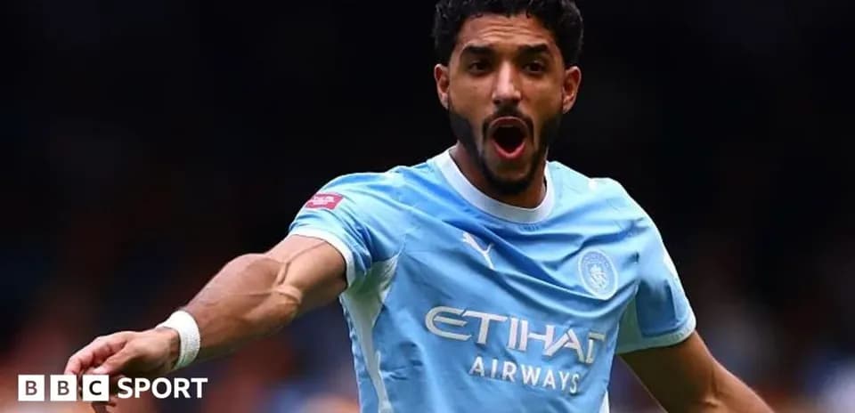 Player celebrating during a match for Manchester City