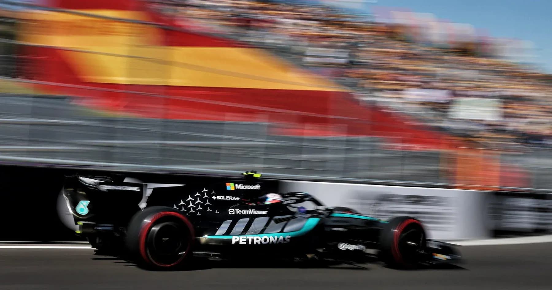 Formula 1 car racing on track at high speed
