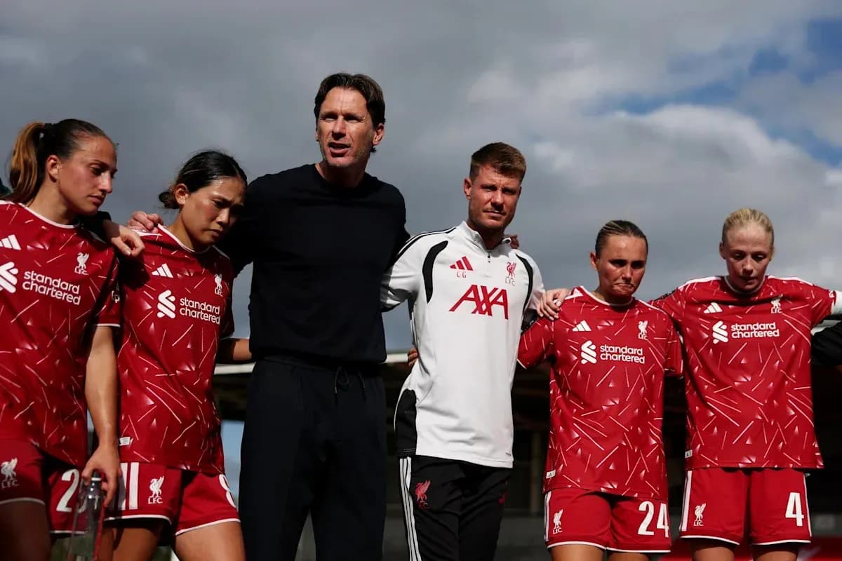 Liverpool women's team in huddle with coaching staff
